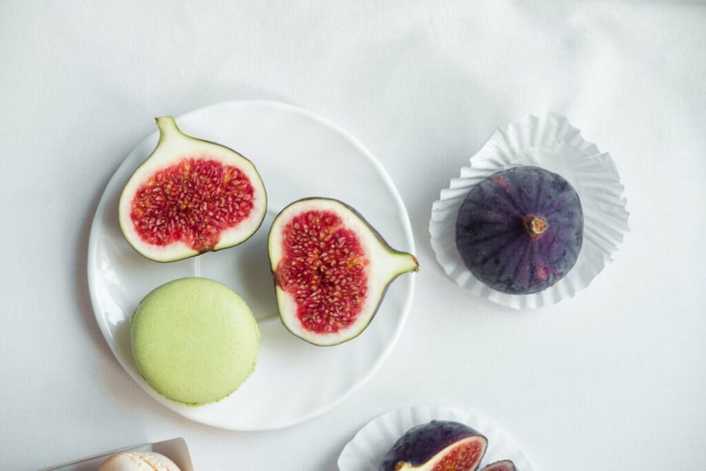 aesthetic layout of figs and macarons on a white background, top view
